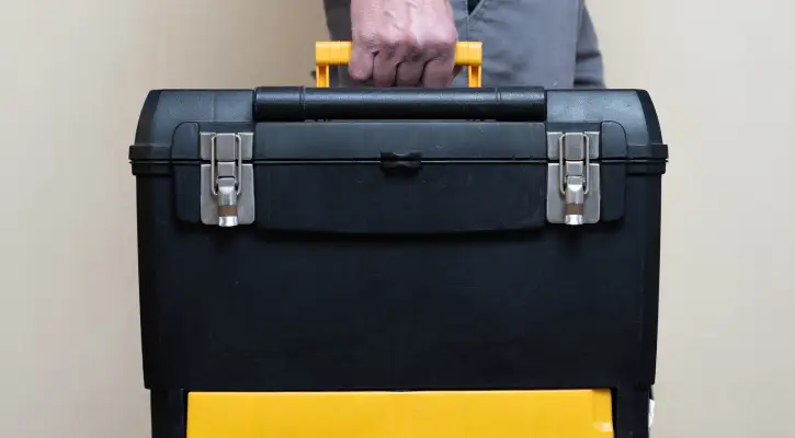 A plumber holding a tool box, ready to offer excellent Plumbing Services in Danvers IL