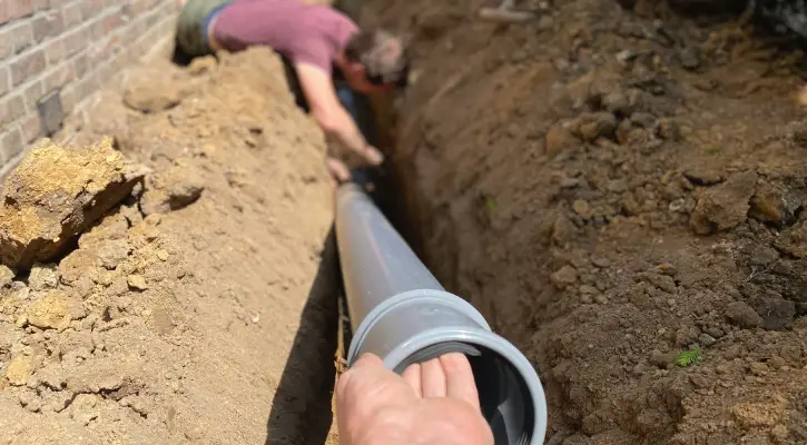 Plumbers laying new sewer lines during Sewer Line Installation & Excavation services from Everything Water